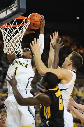 Michigan freshman Glenn Robinson III takes the ball to the hoop over freshman Mitch McGary and Iowa freshman Anthony Clemmons during the first half against Iowa at Crisler Center on Sunday, Jan. 6. Michigan beat Iowa 95-67 in the Big Ten home opener. Melanie Maxwell I AnnArbor.com